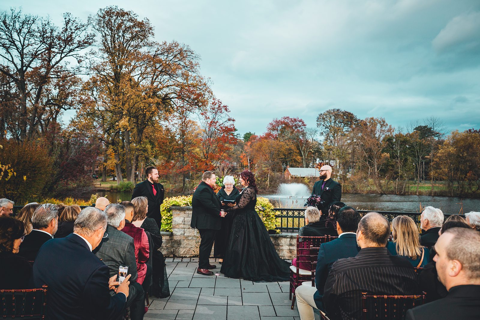 Full ceremony scene at The Pond House with autumn colors