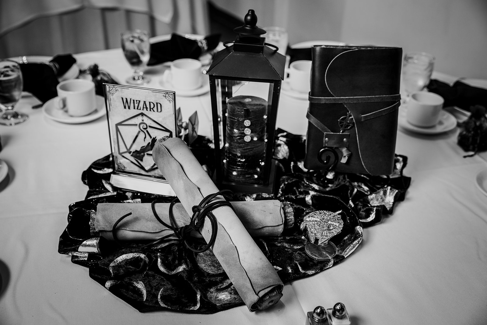Wizard table centerpiece with scrolls, lantern, and spellbook