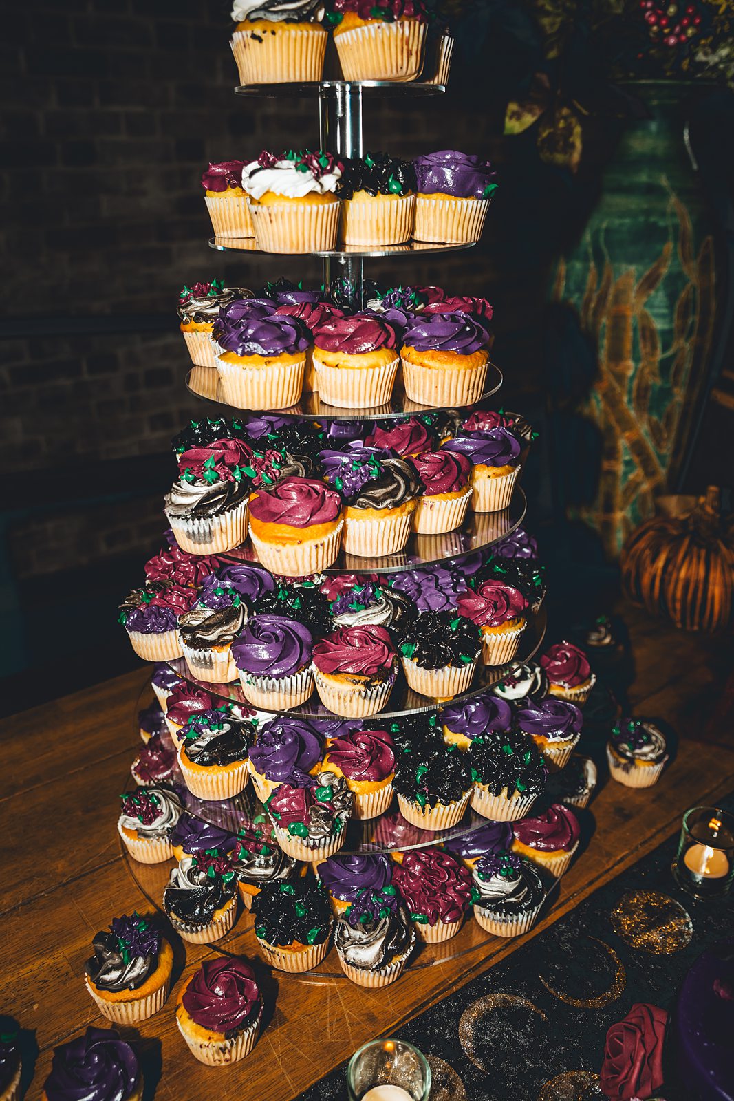 Purple and black cupcake tower with jewel-toned frosting