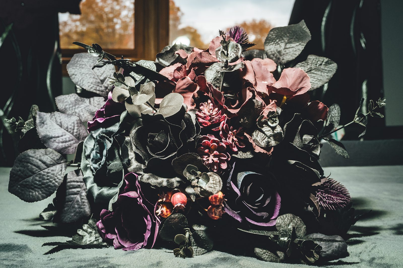 Dark moody bridal bouquet with deep purple and black flowers